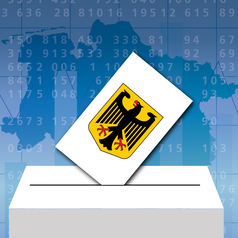 Im Hintergrund ist eine Niedersachsen-Karte mit Zahlen drauf zu sehen. Im Vordergrund ist eine symbolische Wahlurne, in der ein Stimmzettel mit einem Adler drauf steckt.