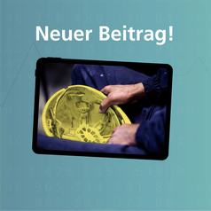 Auf dem Bildschirm eines Tablets ist der gelbe Helm eines Arbeiters zu sehen.