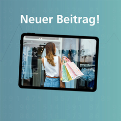 Auf dem Bildschirm ist eine Frau mit Einkaufstüten vor einem Modegeschäft zu sehen.